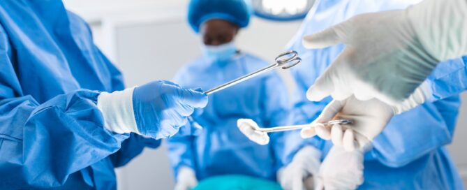 A surgeon and his wearing blue masks performing surgery and swapping instruments.